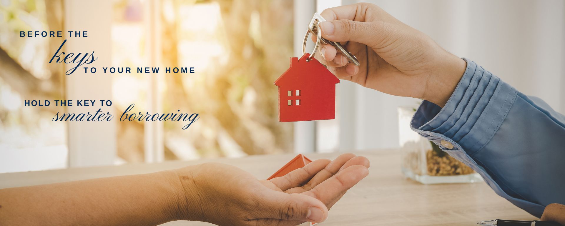 Handing over house key with keychain, symbol of homeownership and smarter borrowing